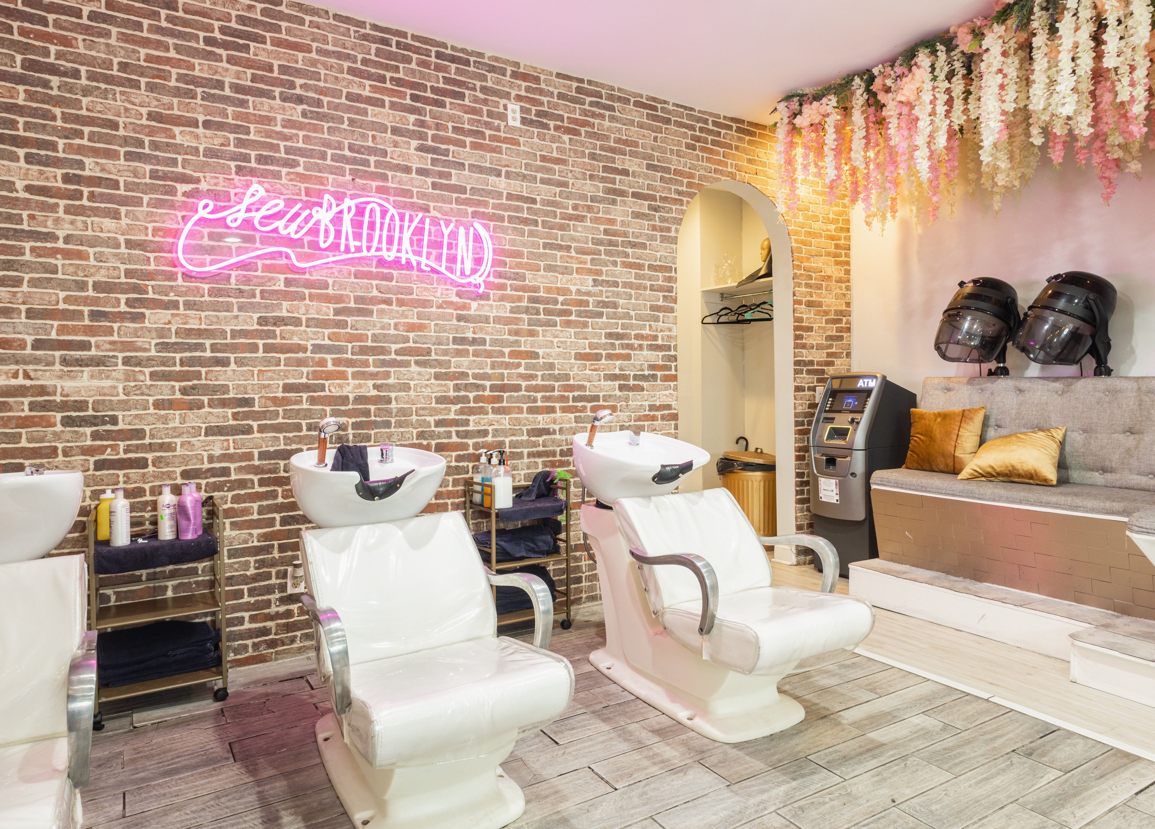 Modern hair washing area at Sew Brooklyn Hair Extension Lounge in New York, New York, US, with stylish decor.