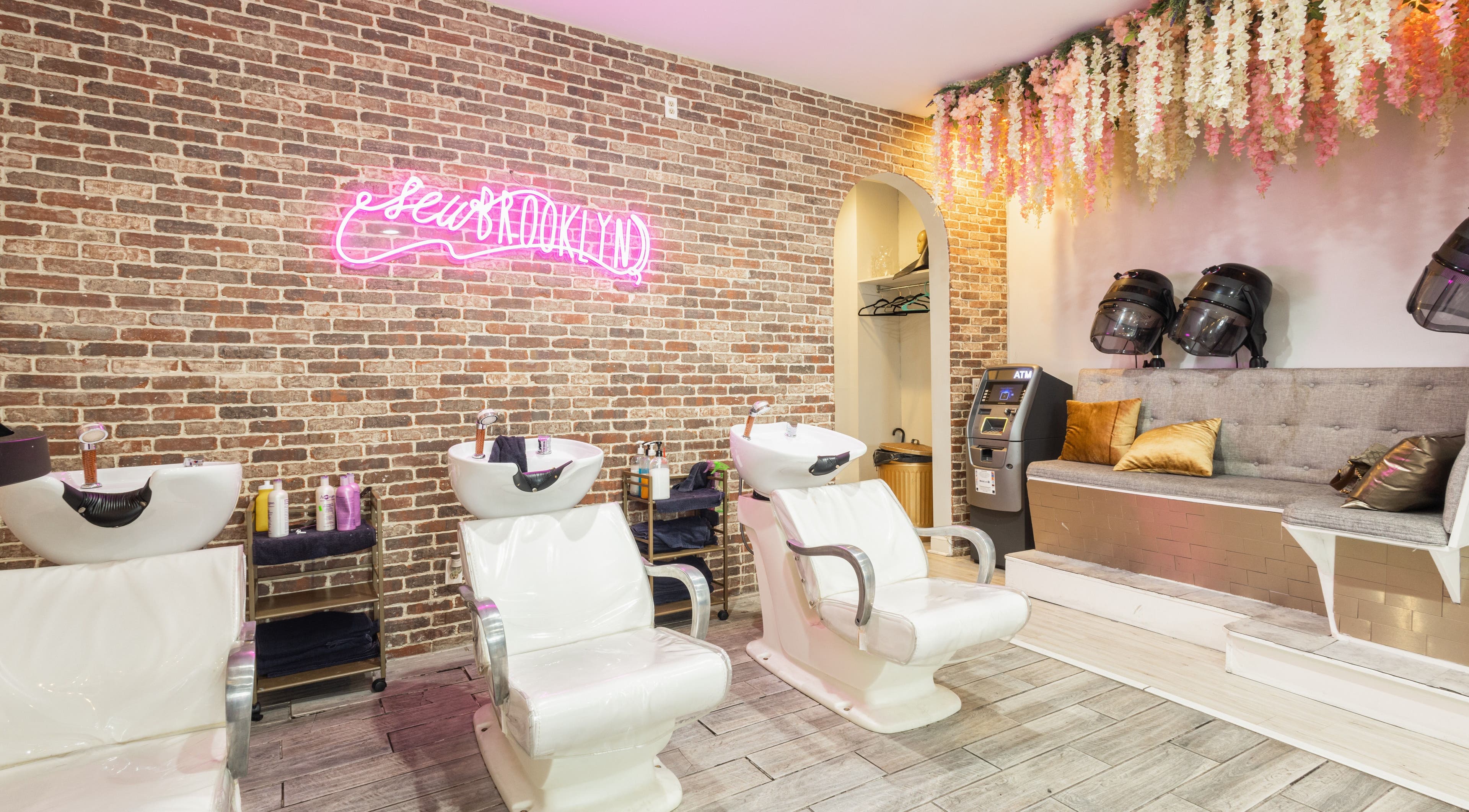 Modern hair washing area at Sew Brooklyn Hair Extension Lounge in New York, New York, US, with stylish decor.