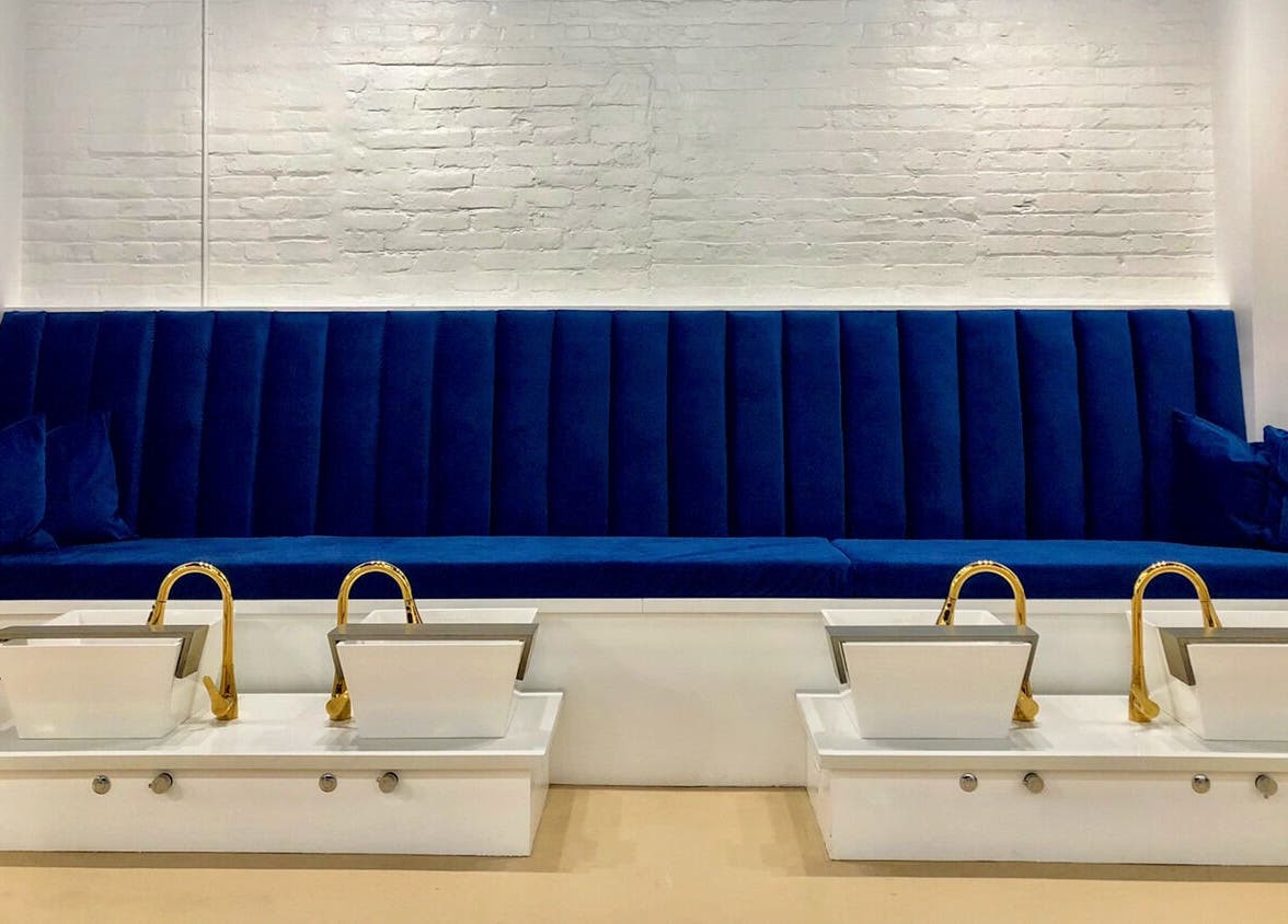 Elegant blue seating with gold sinks at Eversaint Salon in New Orleans, Louisiana, US.