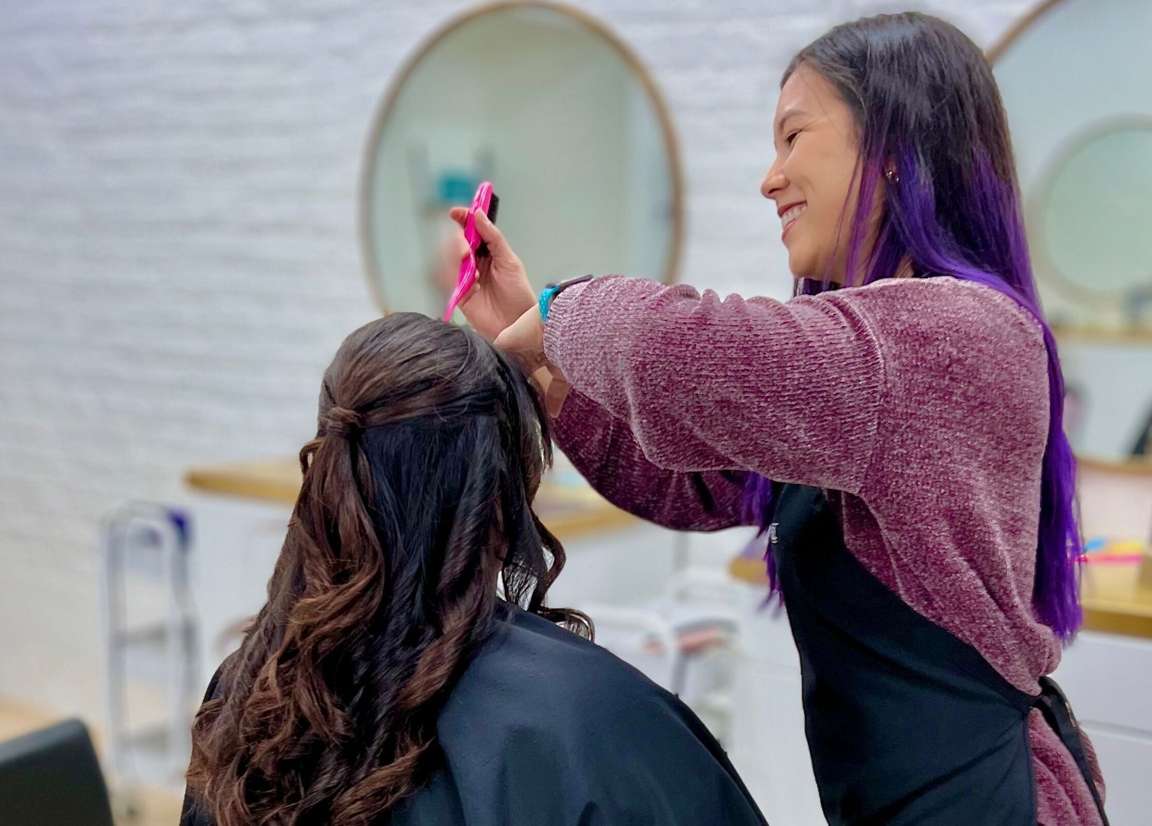 Hairstylist creating elegant look at Eversaint Salon in New Orleans, Louisiana, US.