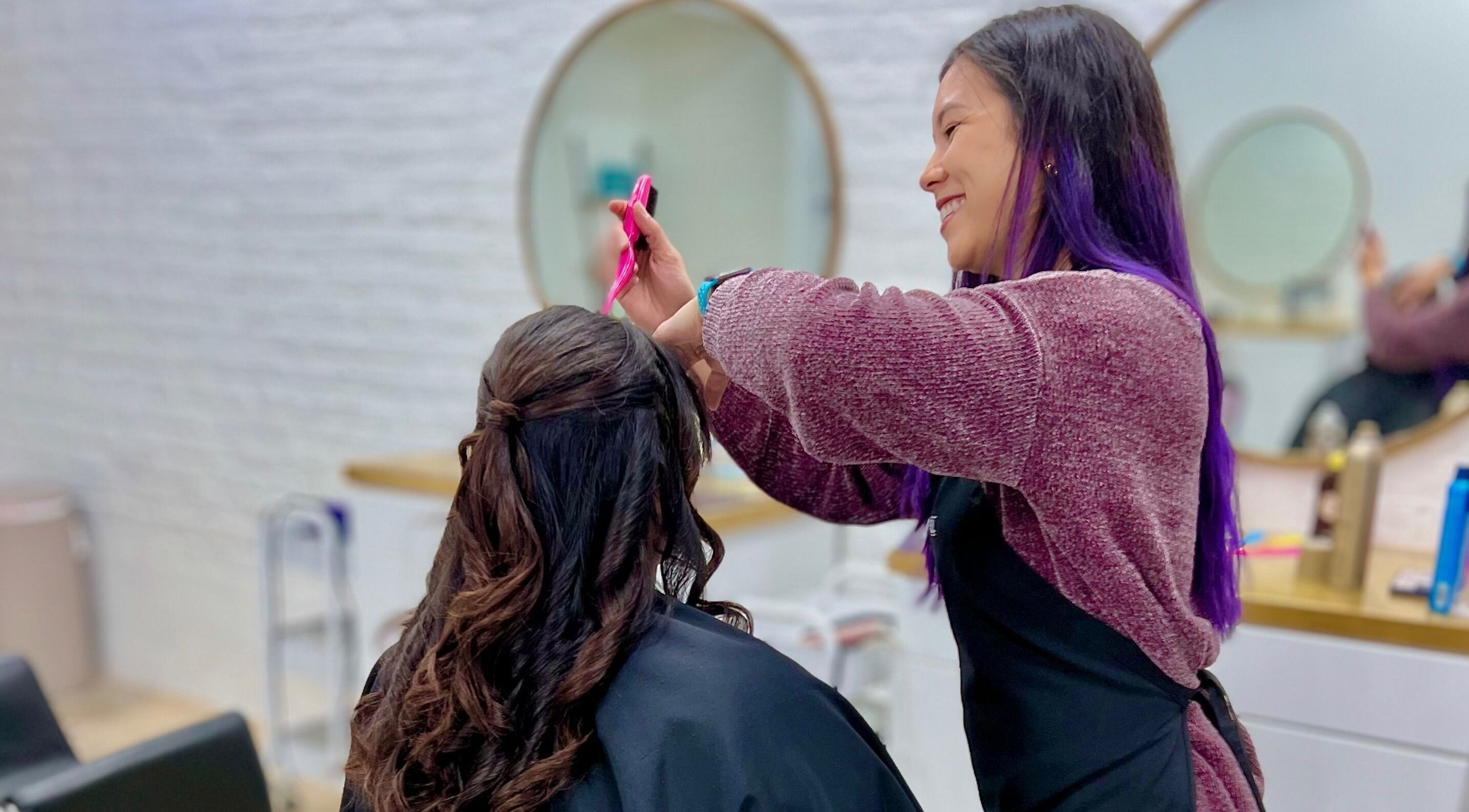 Hairstylist creating elegant look at Eversaint Salon in New Orleans, Louisiana, US.