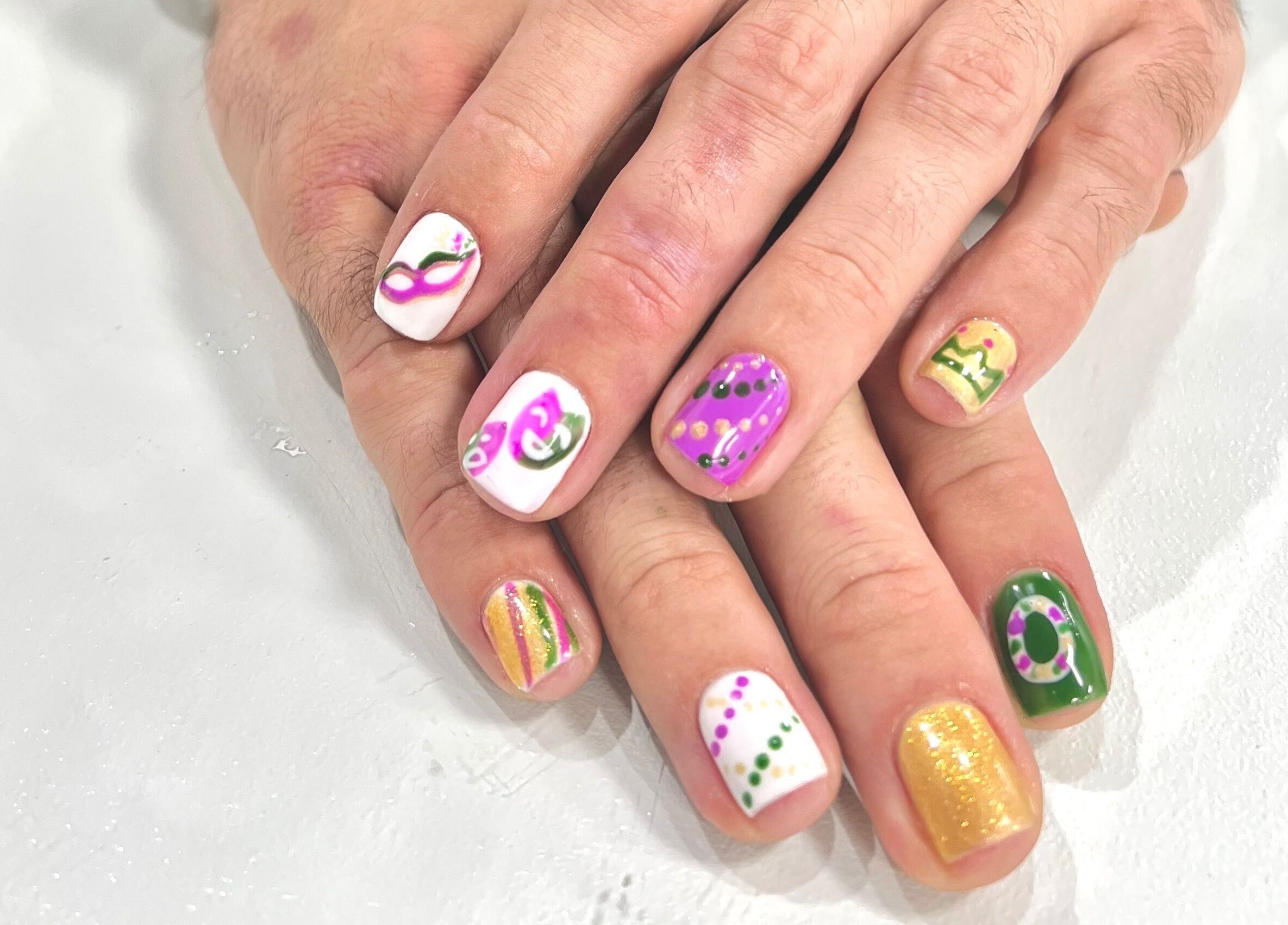 Colorful Mardi Gras nail art at Eversaint Salon, New Orleans, Louisiana, US.