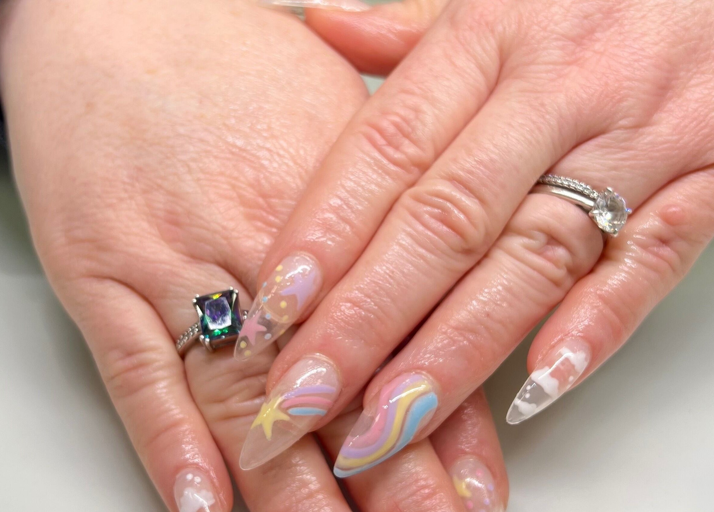 Colorful cosmic nail art at Eversaint Salon, New Orleans, Louisiana, US, showcasing intricate designs.