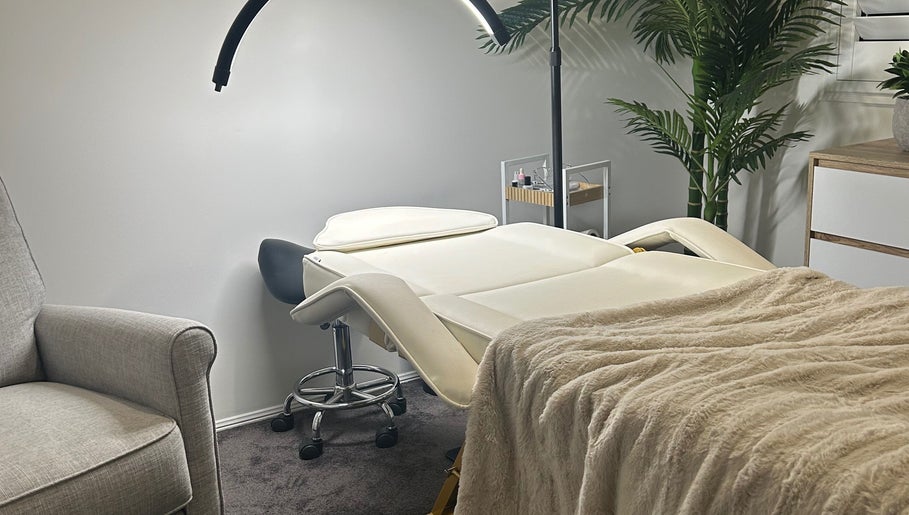 Cozy treatment room at Aura Wellness Studio, Reedy Creek, Queensland, AU with a soft massage bed and ambient lighting.