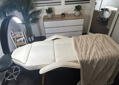 Massage table at Aura Wellness Studio, Reedy Creek, Queensland, AU, with cozy blanket and ambient lighting.