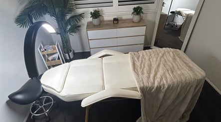 Massage table at Aura Wellness Studio, Reedy Creek, Queensland, AU, with cozy blanket and ambient lighting.