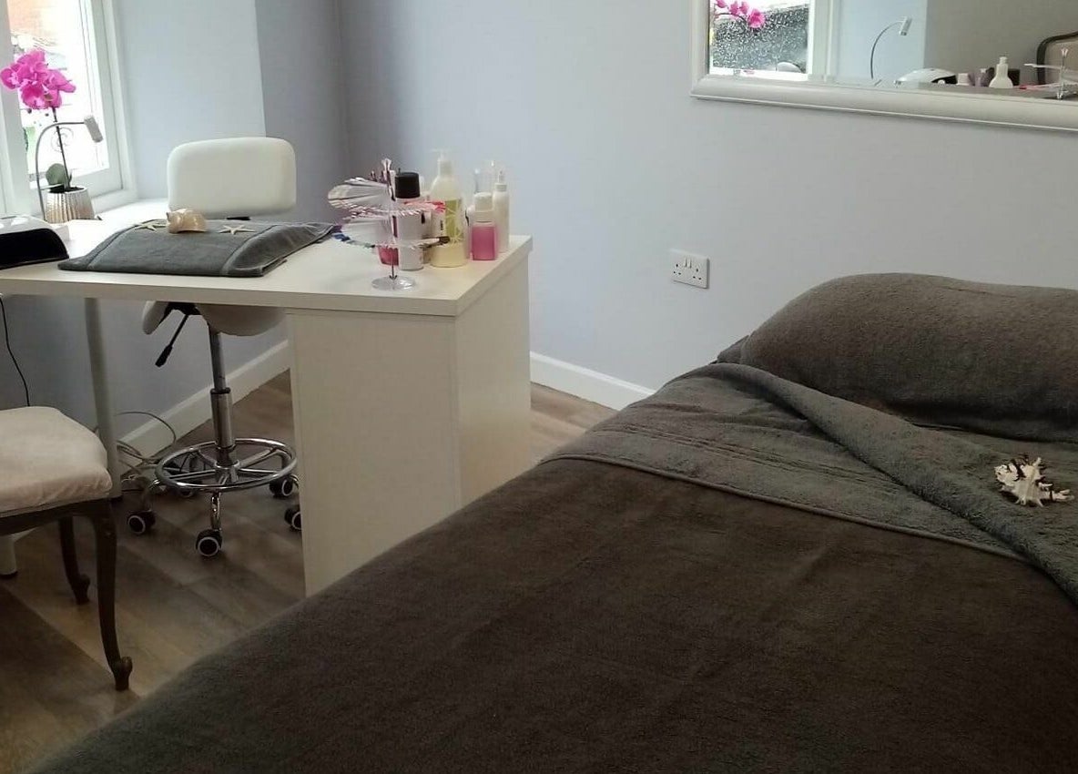 Treatment room at Serenity On The Square, Holsworthy, England, GB with relaxing decor and massage bed.