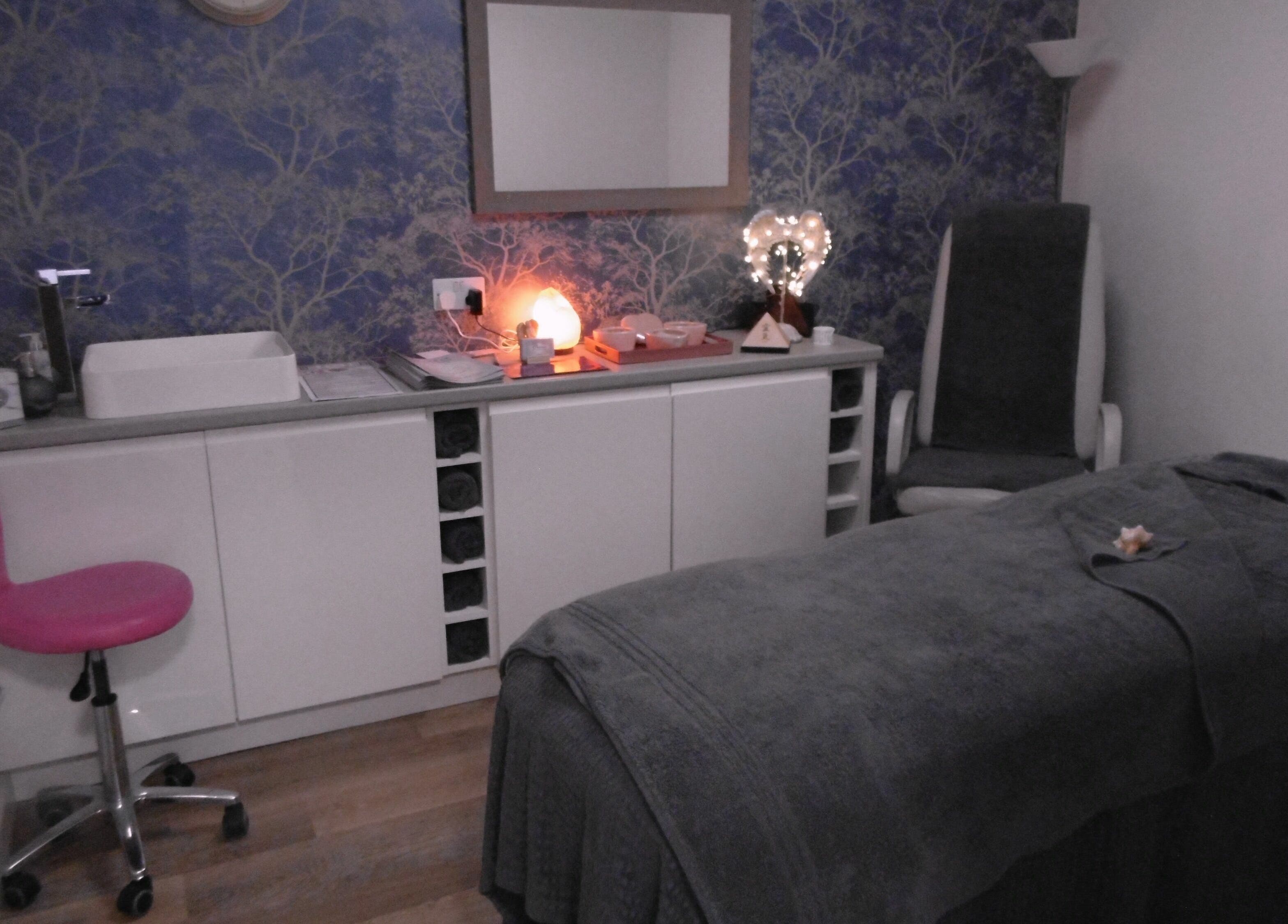 Calming therapy room at Serenity On The Square, Holsworthy, England, GB, featuring a massage bed and soft lighting.