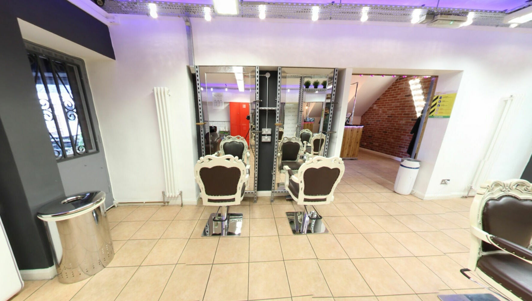 Vo La Si salon with elegant chairs and mirrors in Guisborough, England, GB, creating a chic ambiance.