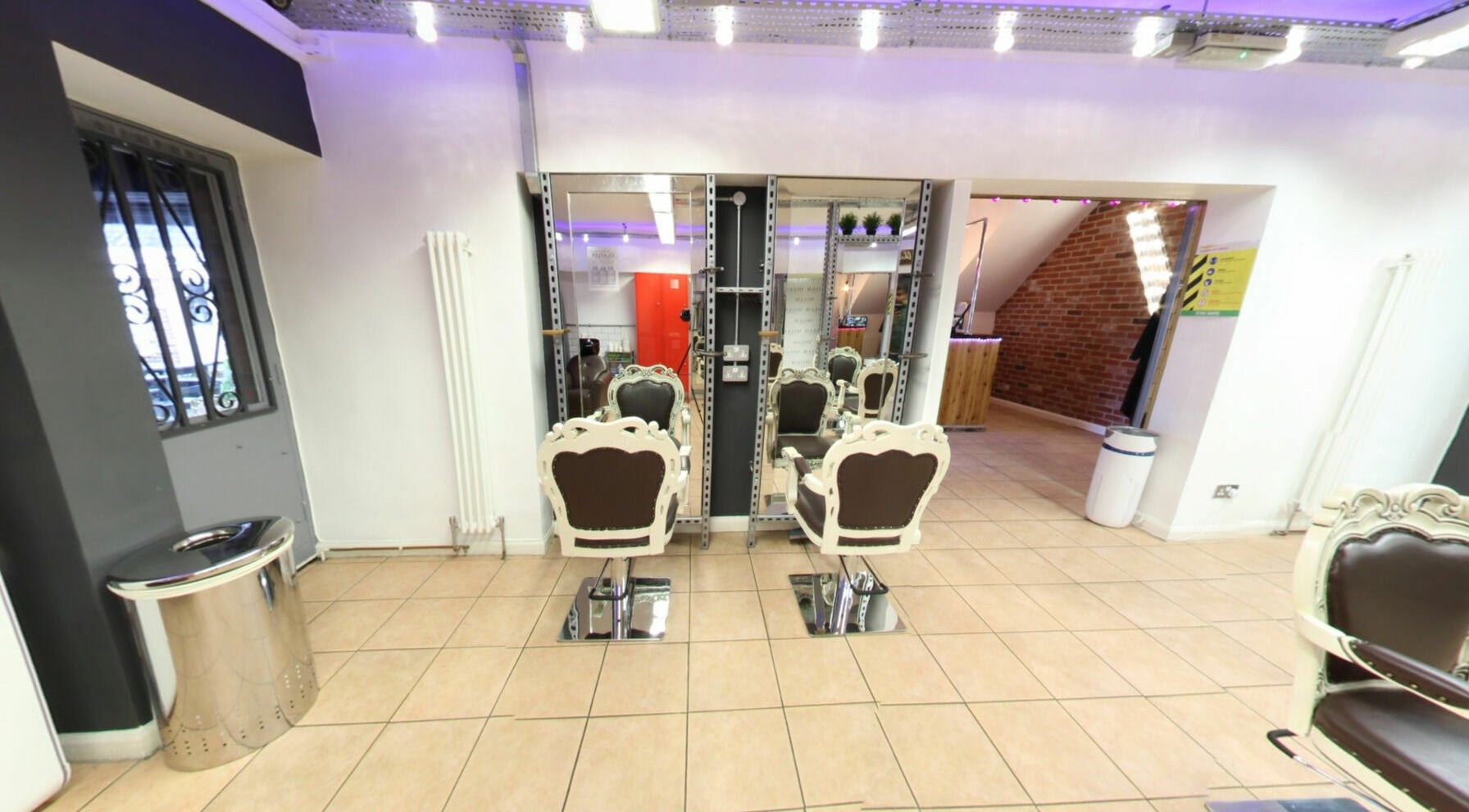 Vo La Si salon with elegant chairs and mirrors in Guisborough, England, GB, creating a chic ambiance.