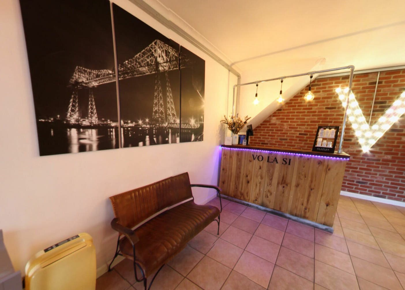 Warm welcoming reception at Vo La Si, Guisborough, England, GB featuring stylish decor and illuminated signage.