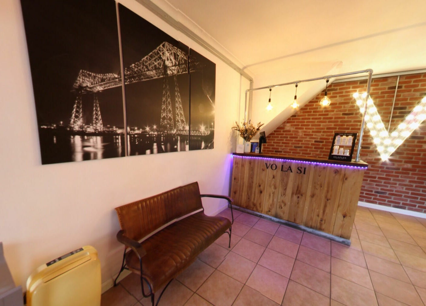 Warm welcoming reception at Vo La Si, Guisborough, England, GB featuring stylish decor and illuminated signage.