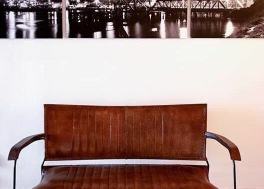 Stylish brown seating in Vo La Si, Guisborough, England, GB with cityscape artwork.