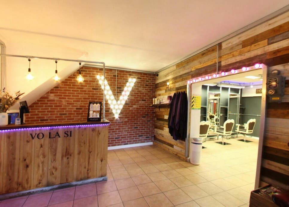 Reception area of Vo La Si, Guisborough, England, GB with wooden decor and ambient lighting.