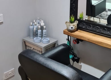 Cozy corner at Alter Ego with grooming products and plush seating in Worcester, England, GB.