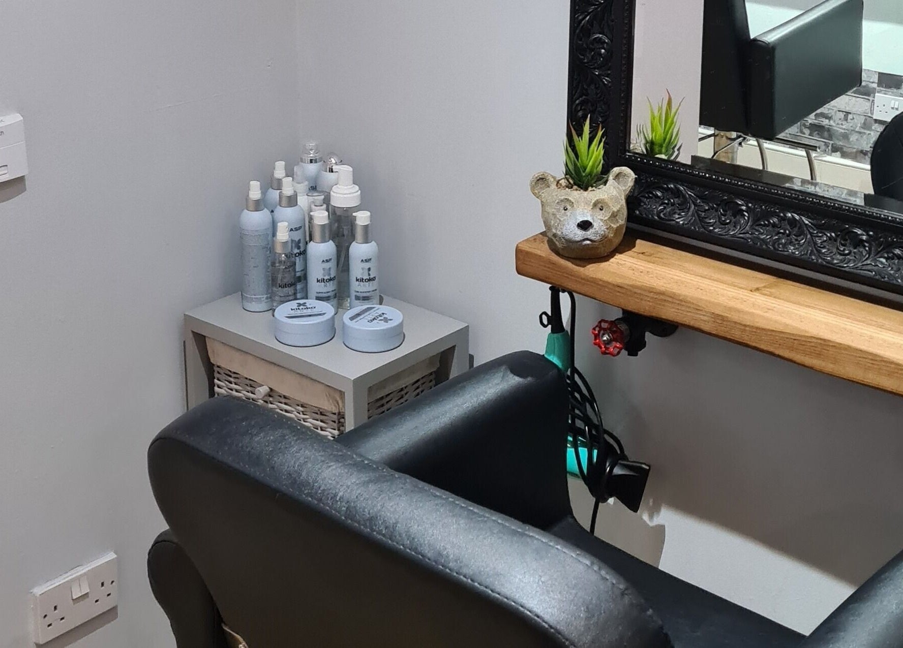 Cozy corner at Alter Ego with grooming products and plush seating in Worcester, England, GB.