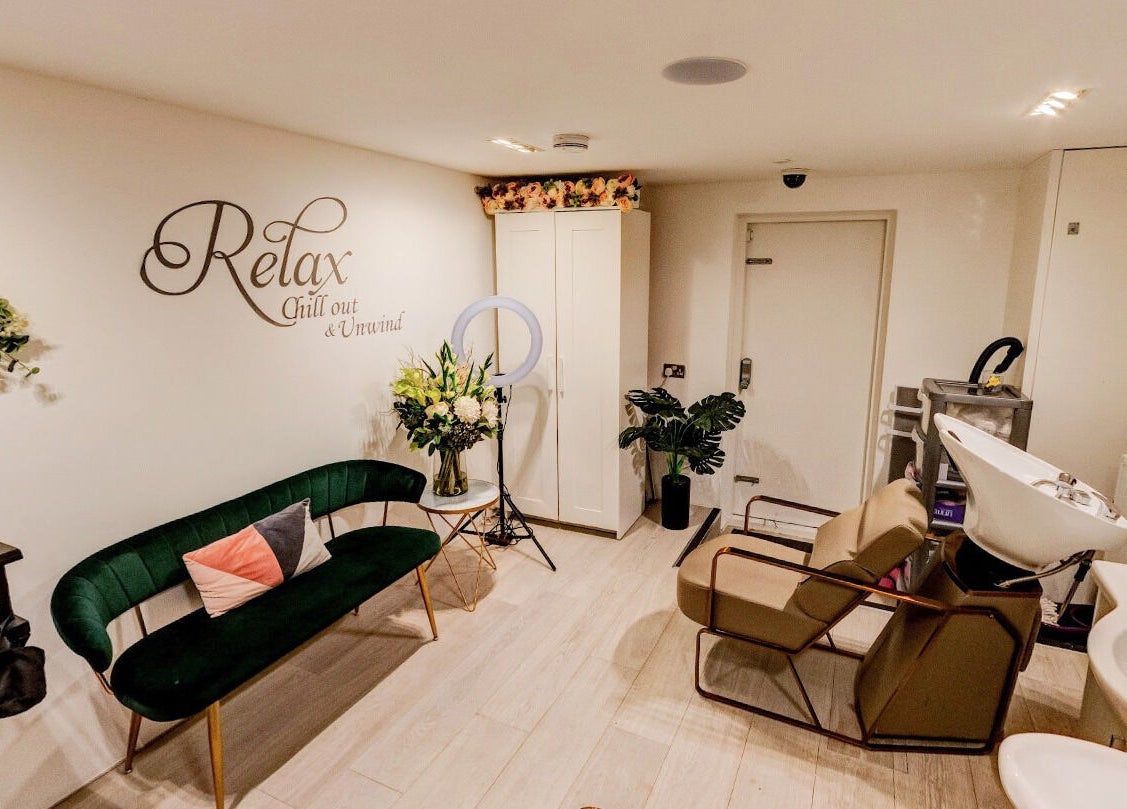 Becca Hair and Beauty Salon's stylish interior in Barnet, England, GB: lush seating and ornate wall decor.