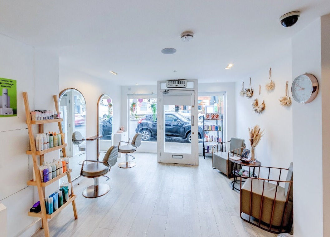 Interior of Becca Hair and Beauty Salon showing chic chairs and products in Barnet, England, GB.