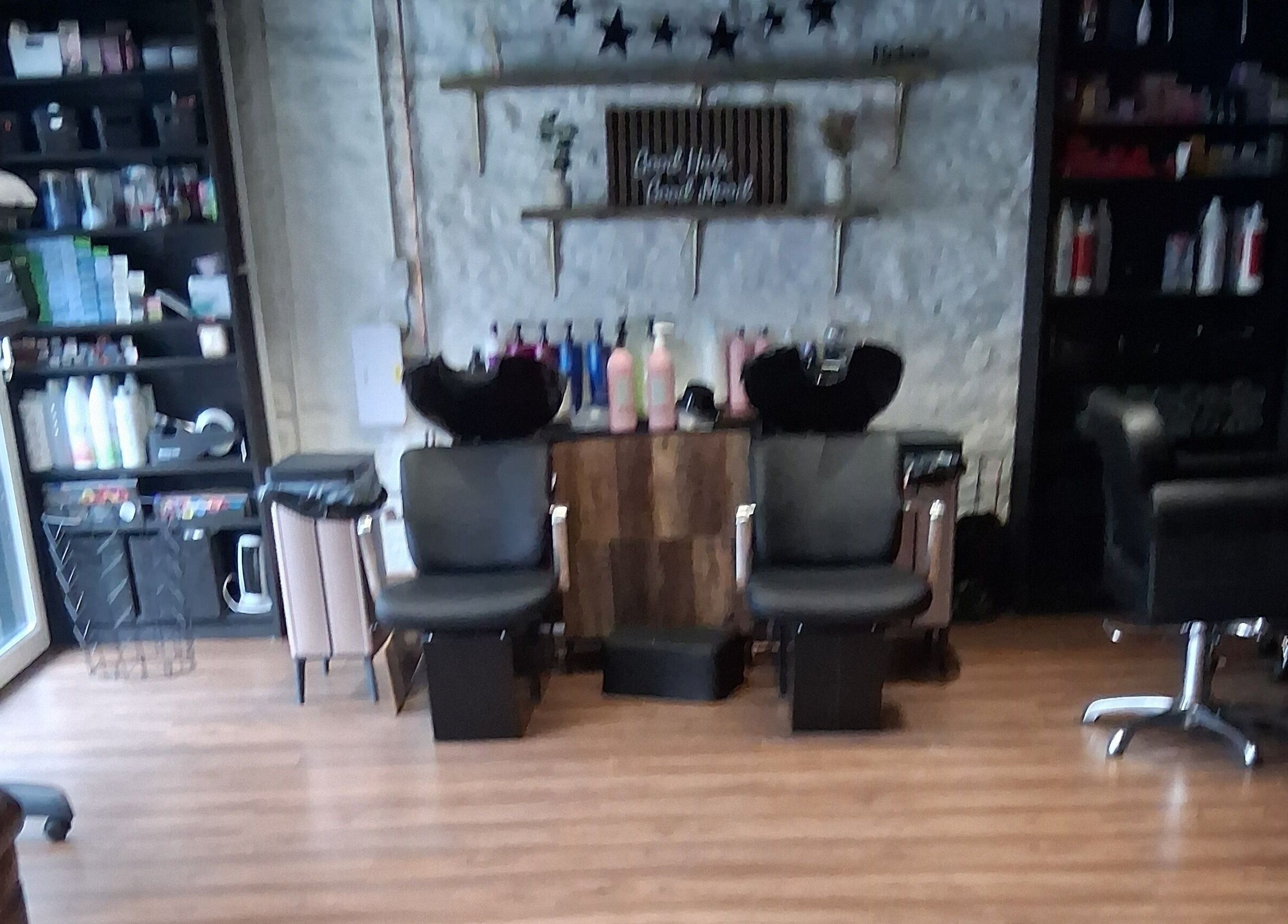 Stylish interior of Hair By Joy in Lockerbie, Scotland, GB with modern salon chairs and products.