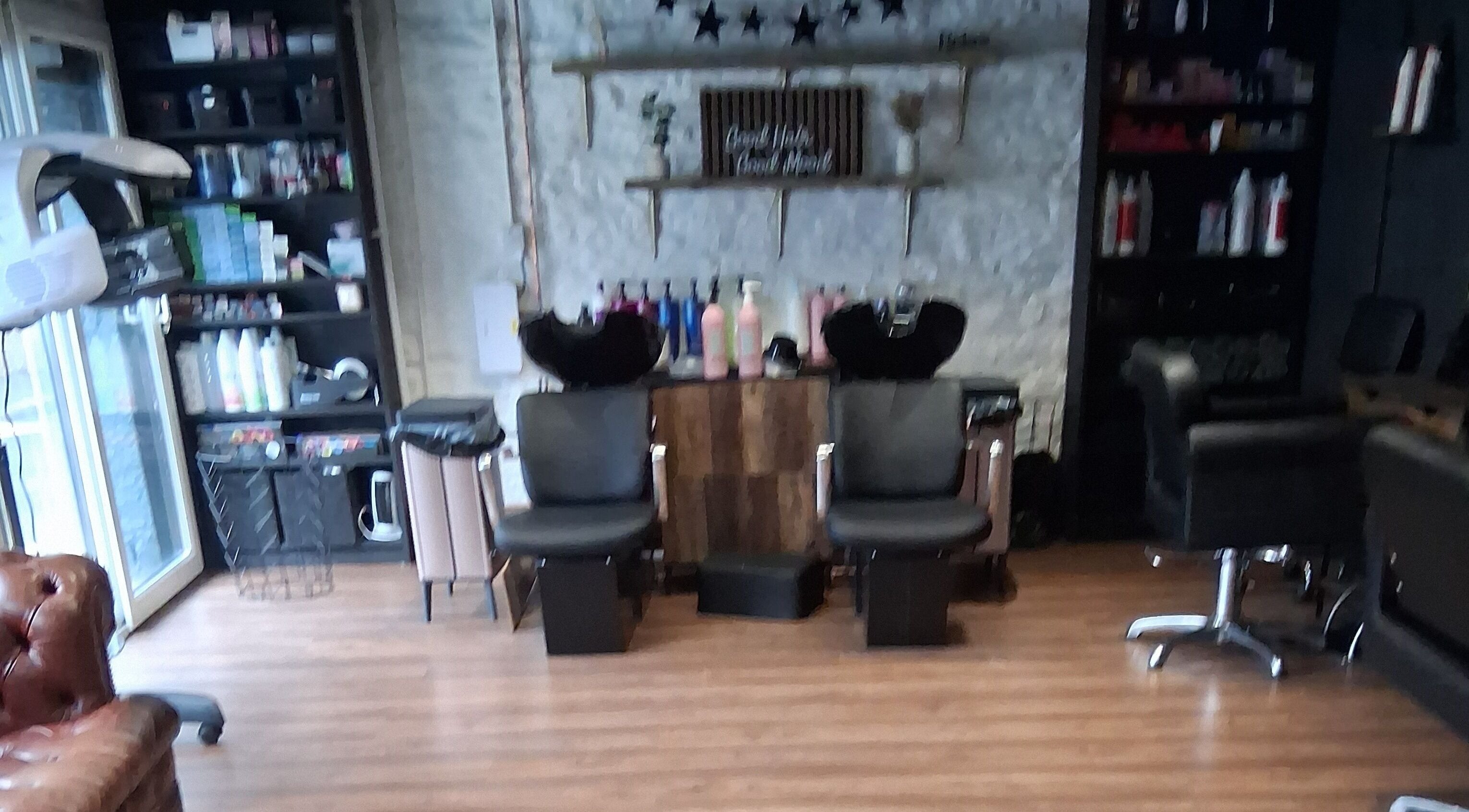 Stylish interior of Hair By Joy in Lockerbie, Scotland, GB with modern salon chairs and products.