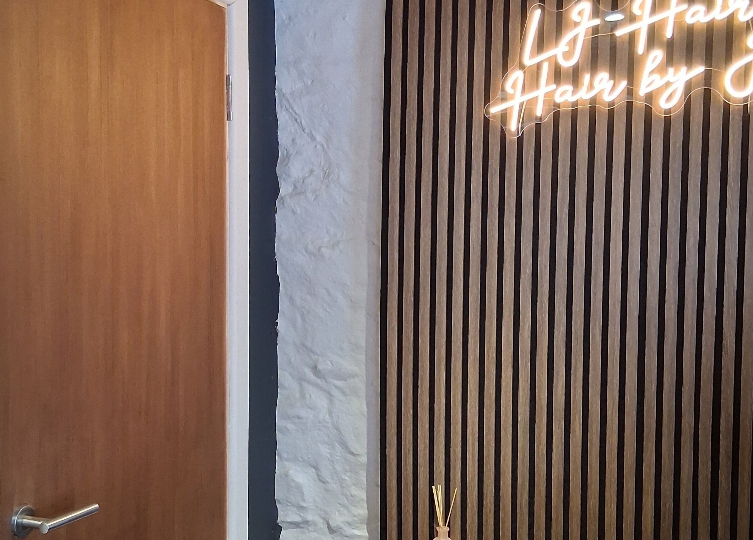 Neon sign at Hair By Joy in Lockerbie, Scotland, GB, showcasing modern interior design.