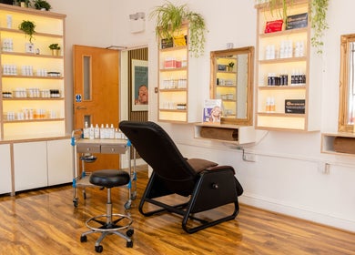 Relaxing skincare room at Mg Skincare, TOWER BRIDGE LONDON, England, GB, featuring cozy seating and product display.