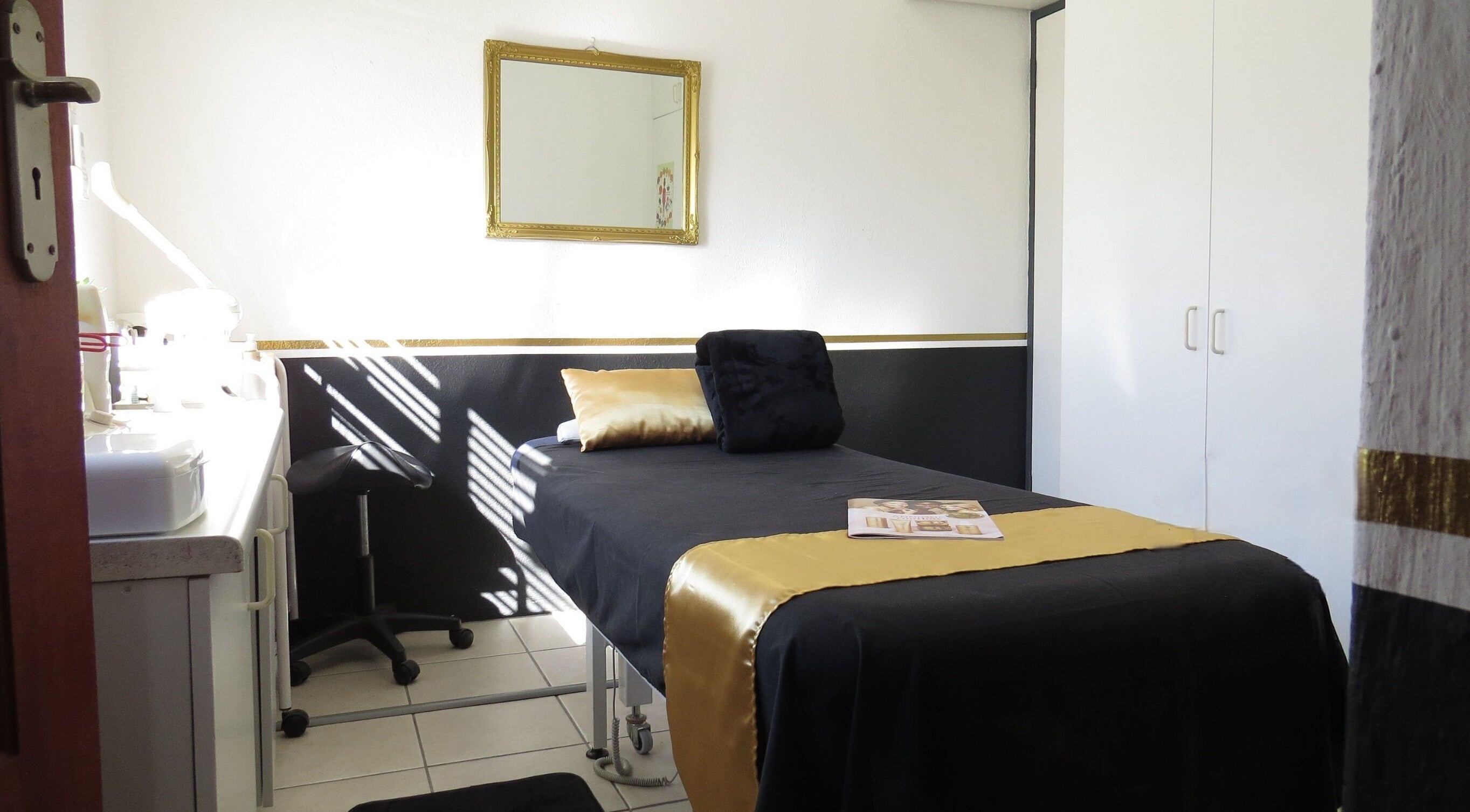 Relaxing spa room at Beauty by Hanna, Cape Town, Western Cape, ZA, featuring a stylish massage table.