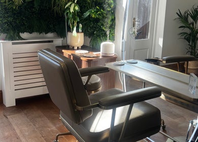 Relaxing salon chair at Lengths | By CJP, Writtle, England, GB with lush greenery backdrop.