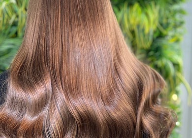 Luxurious brown hair styled at Lengths | By CJP, Writtle, England, GB, surrounded by lush greenery.