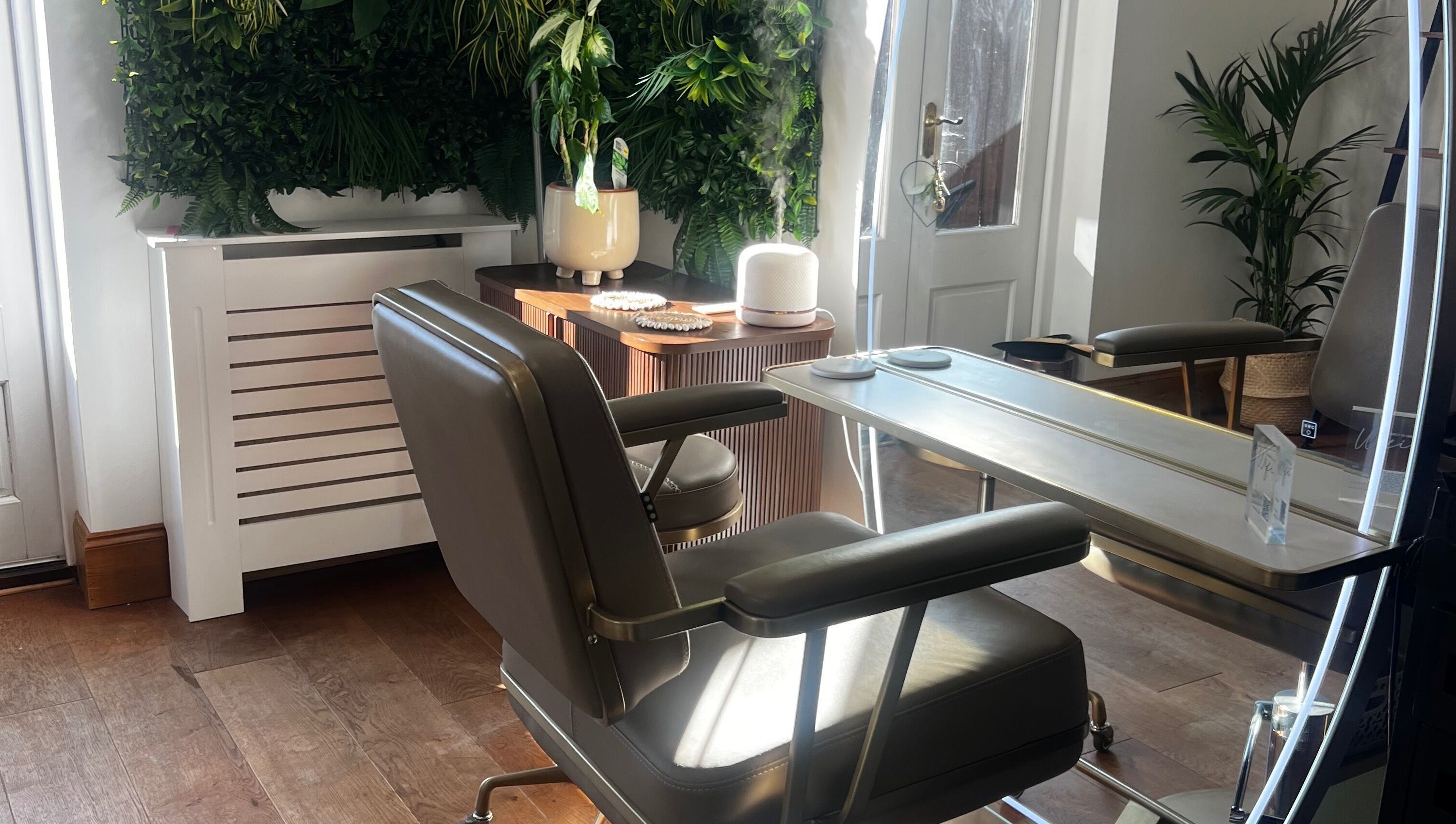Elegant salon seating at Lengths | By CJP in Writtle, England, GB with lush greenery and modern decor.