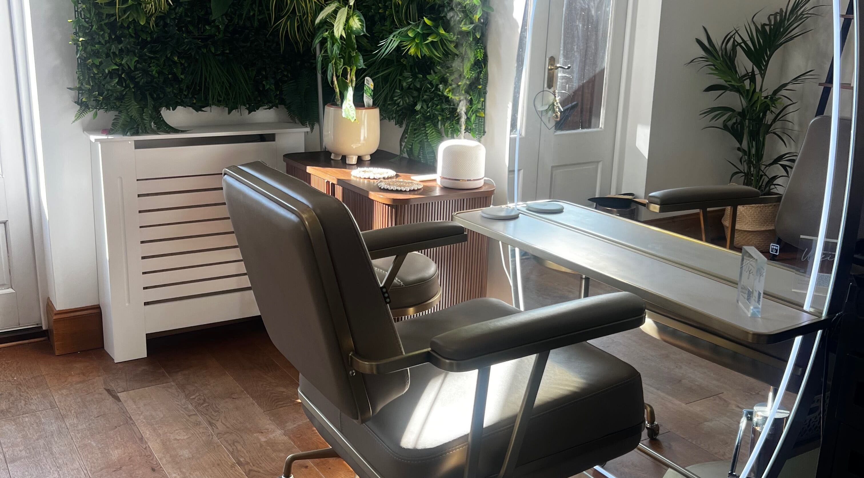 Elegant salon seating at Lengths | By CJP in Writtle, England, GB with lush greenery and modern decor.