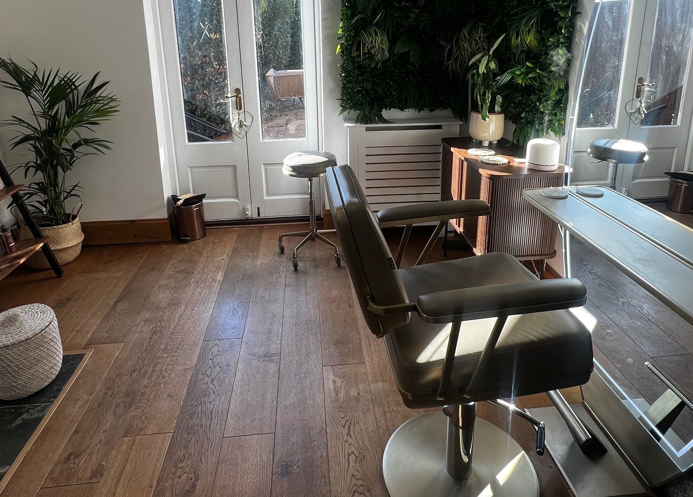 Tranquil salon interior at Lengths | By CJP in Writtle, England, GB, featuring stylish chairs and lush greenery.