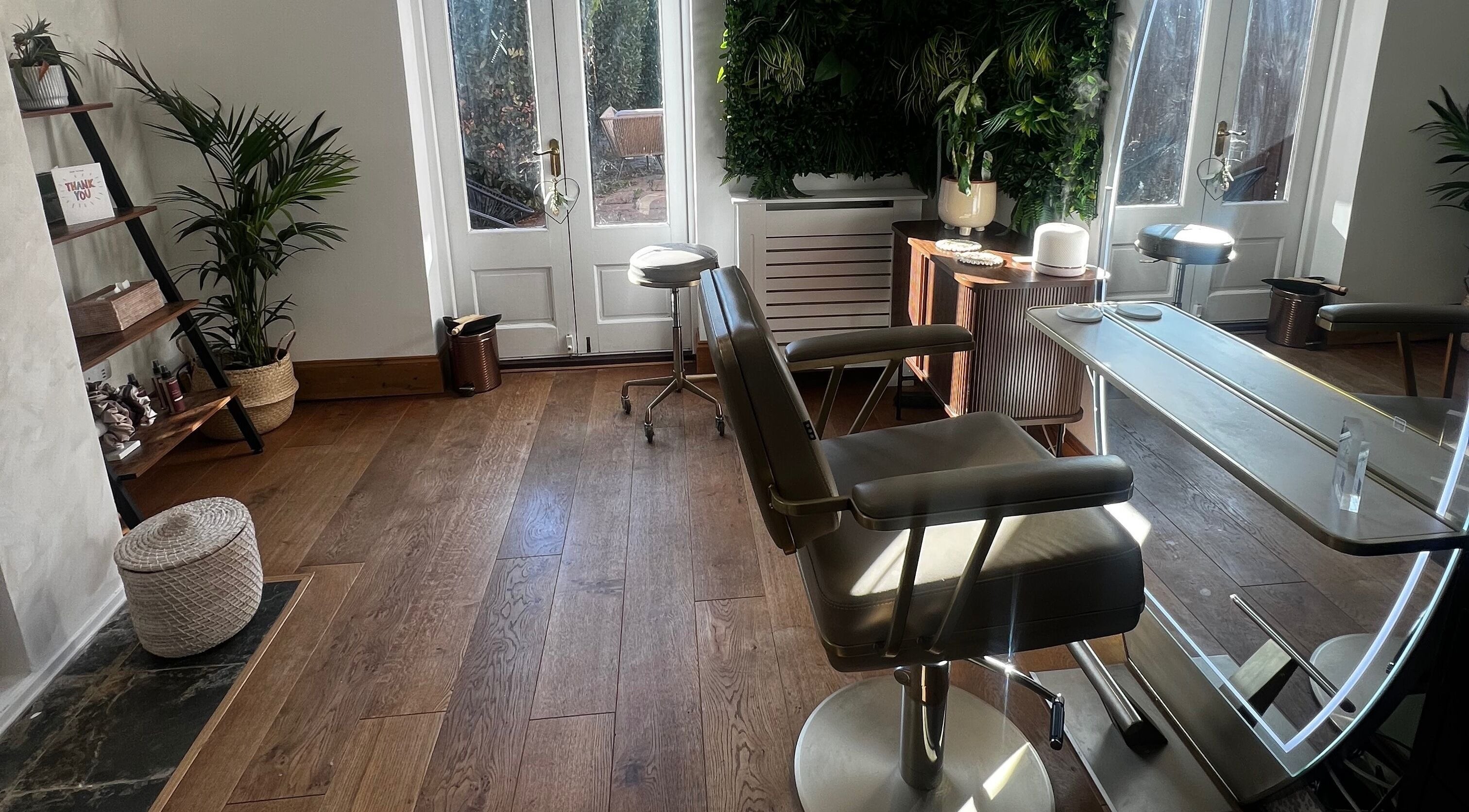 Tranquil salon interior at Lengths | By CJP in Writtle, England, GB, featuring stylish chairs and lush greenery.