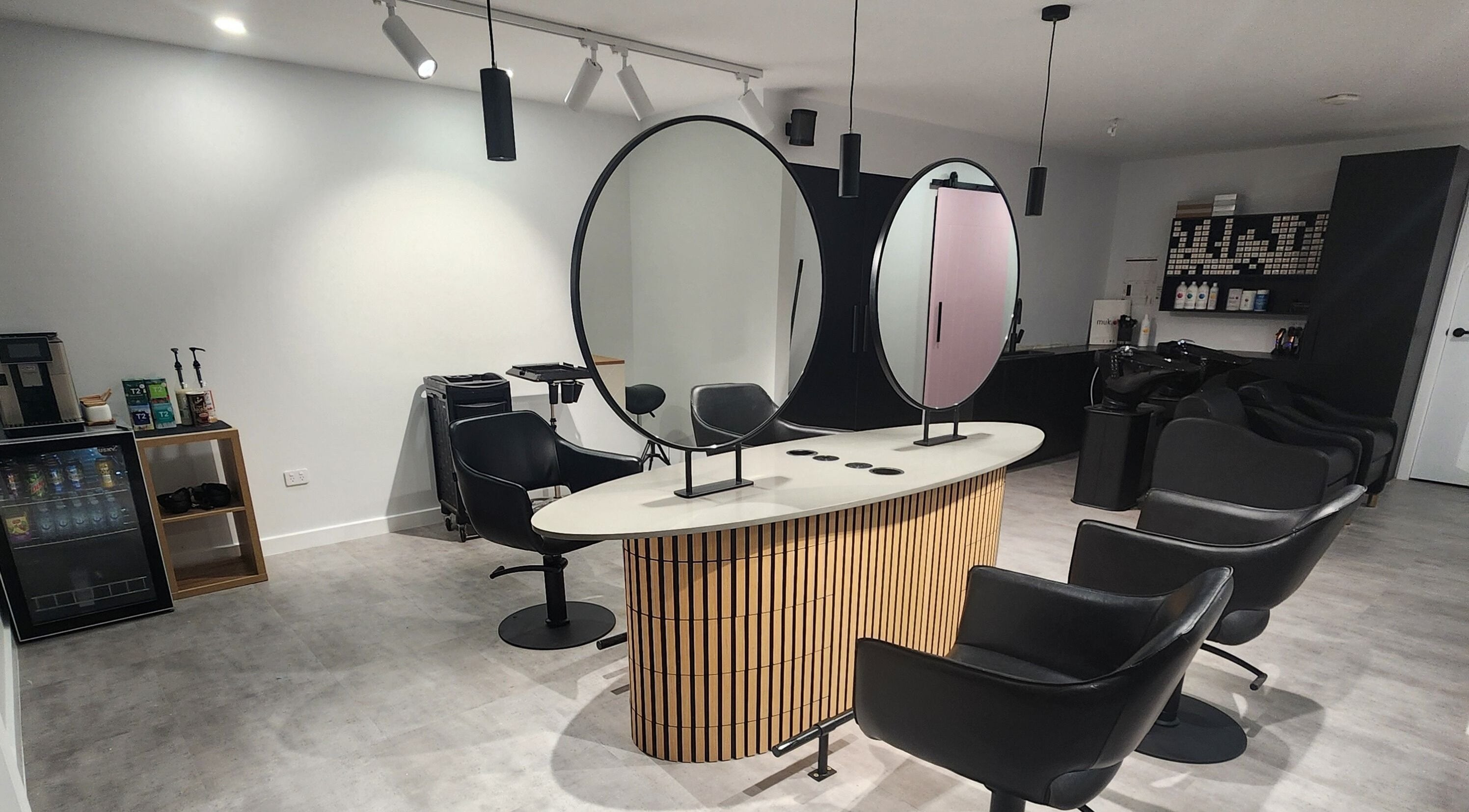 Modern salon interior at Vallee Hair Co, Mulbring, New South Wales, AU. Stylish chairs and mirrors.