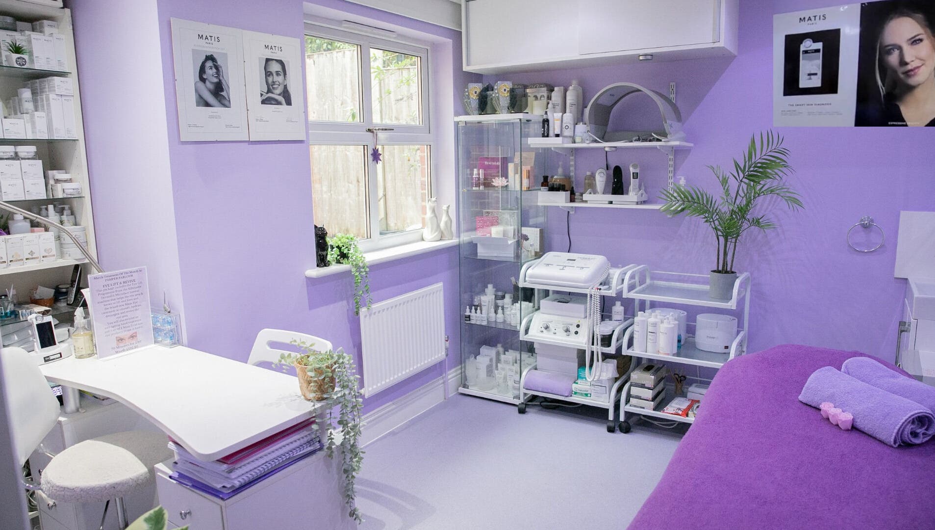 Pamper Parlour in Coulsdon, England, GB features soothing lavender decor with treatment tables and beauty products.