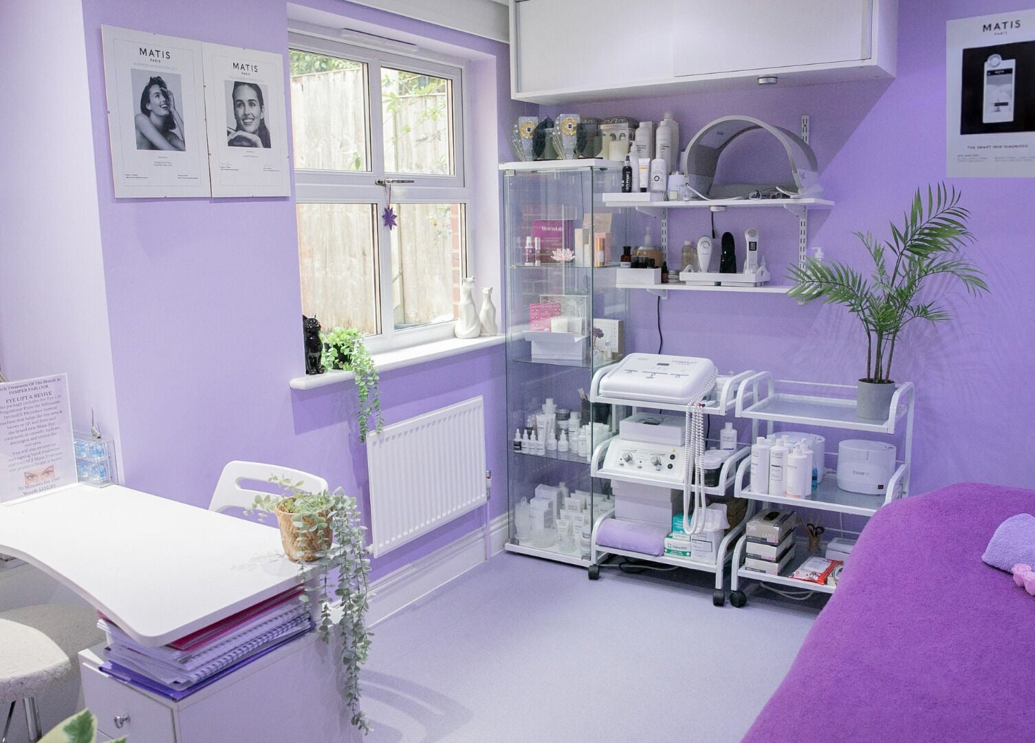 Pamper Parlour in Coulsdon, England, GB features soothing lavender decor with treatment tables and beauty products.