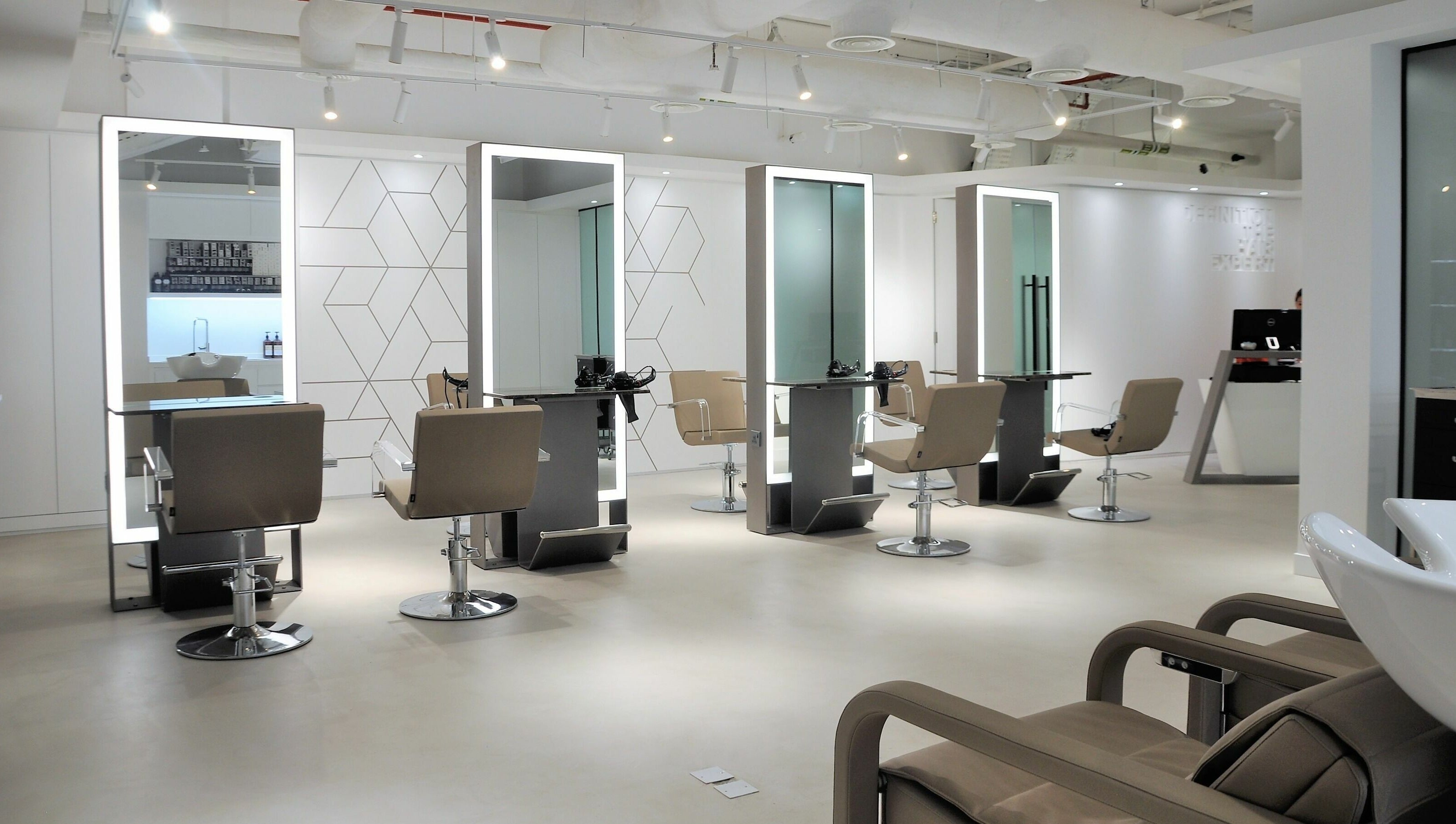 Sleek salon interior at Definition - The Hair Expert in Abu Dhabi, AE, featuring elegant styling stations.