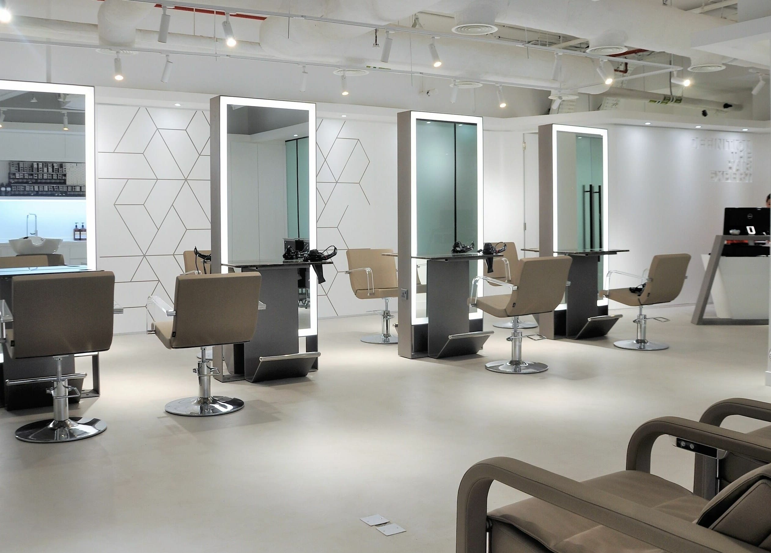 Sleek salon interior at Definition - The Hair Expert in Abu Dhabi, AE, featuring elegant styling stations.