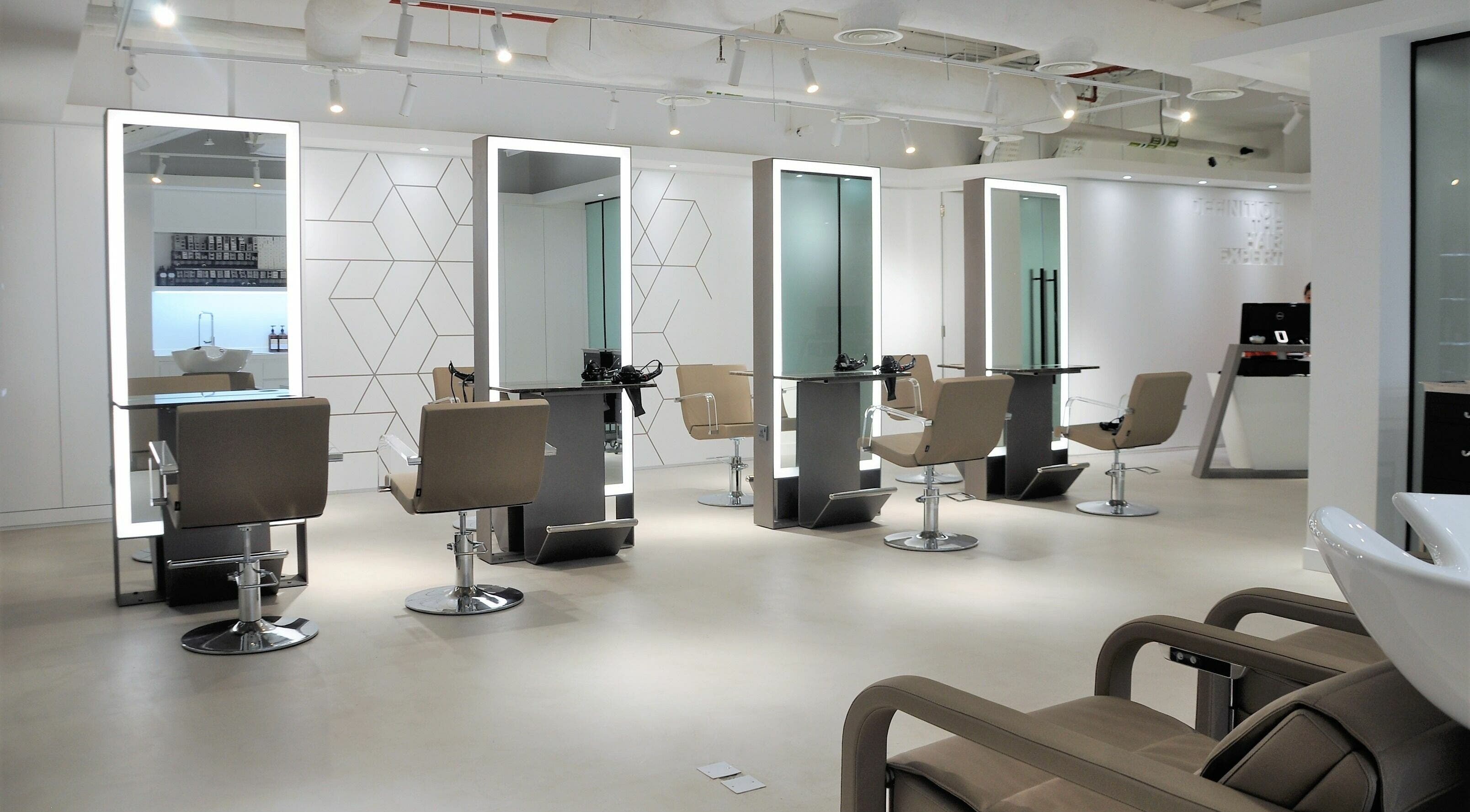 Sleek salon interior at Definition - The Hair Expert in Abu Dhabi, AE, featuring elegant styling stations.