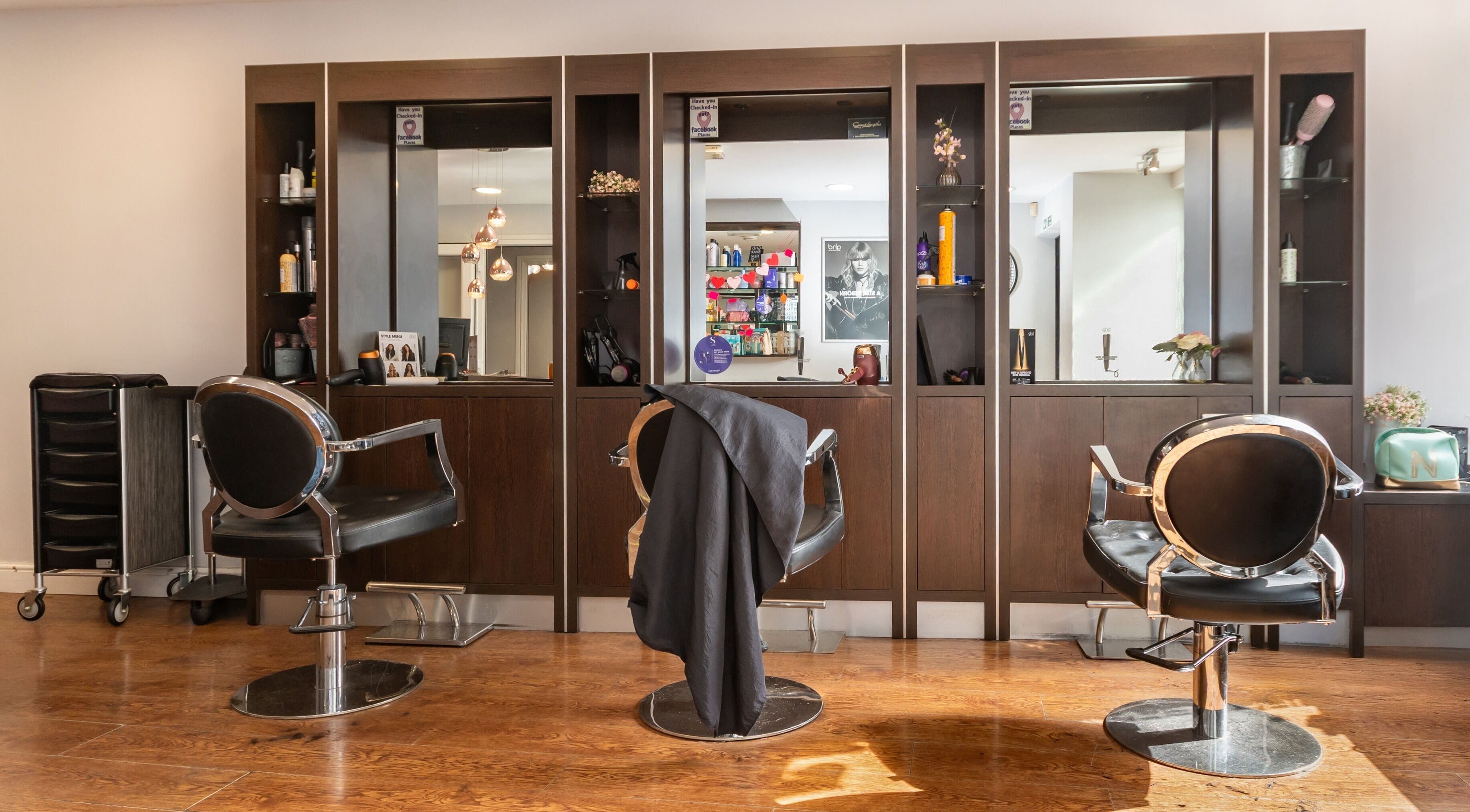 Modern salon interior at Effleurage Hair and Beauty Limited, Langley Mill, England, GB with sleek styling chairs.