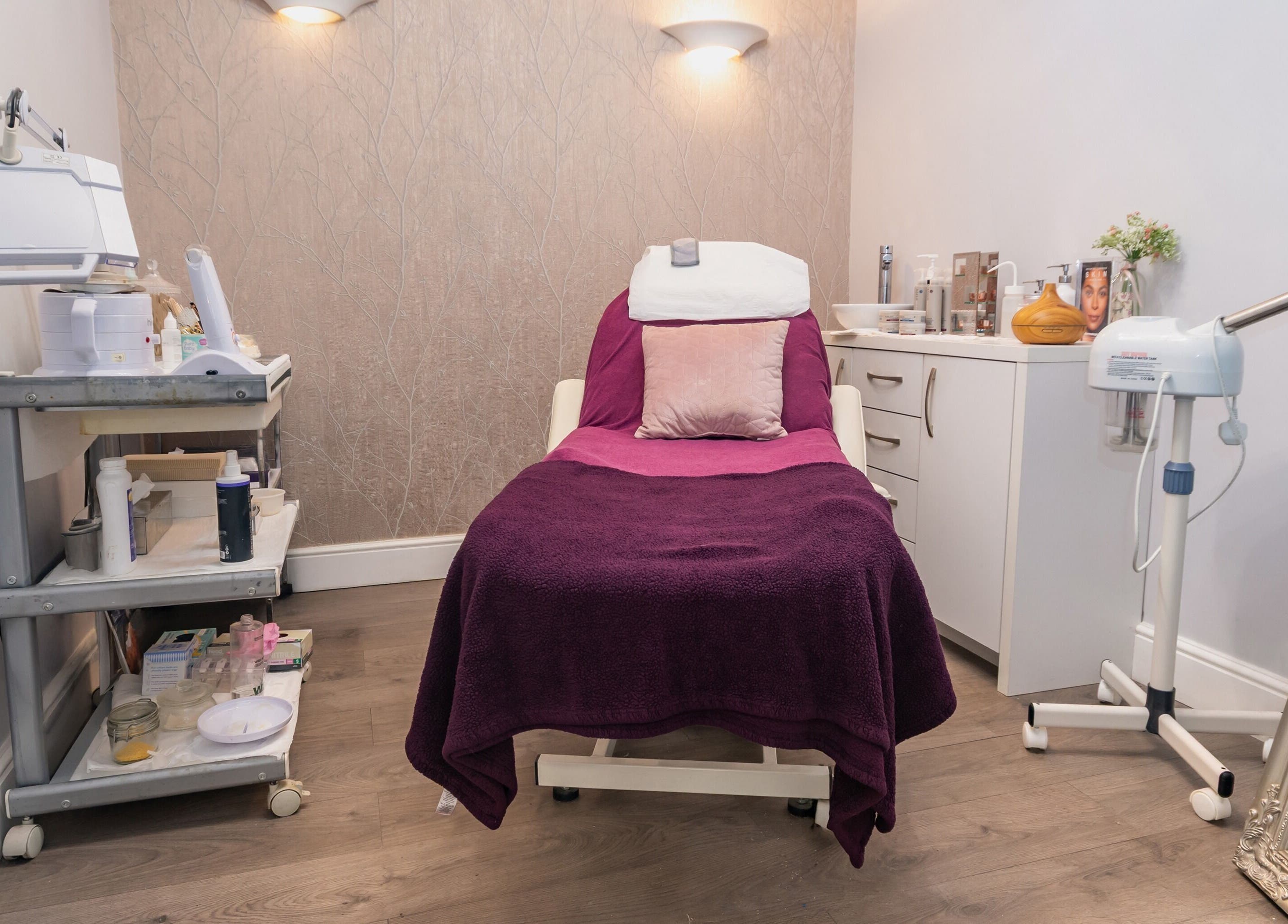 Cozy treatment room at Effleurage Hair and Beauty Limited in Langley Mill, England, featuring a plush treatment bed.