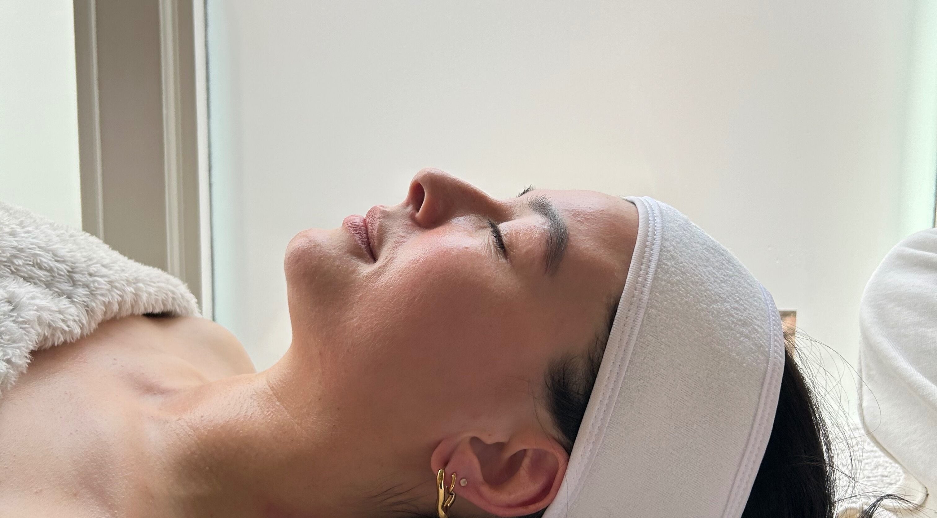 Relaxed woman receiving treatment at Bliss, Penrith, England, GB, showcasing relaxation and wellness.