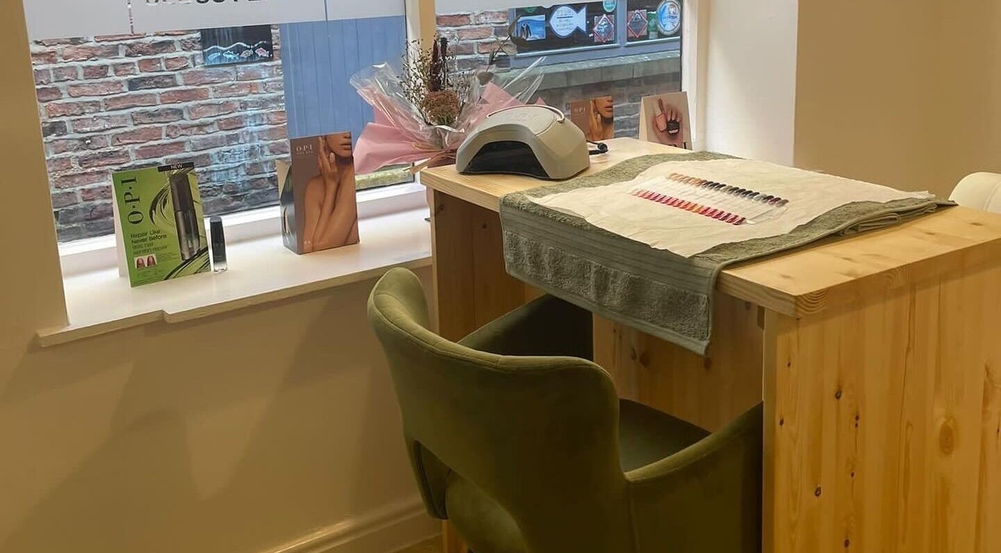 Cozy nail station at Impressions Foot Clinic and Beauty, Yarm, England, GB, featuring manicure tools and seating.