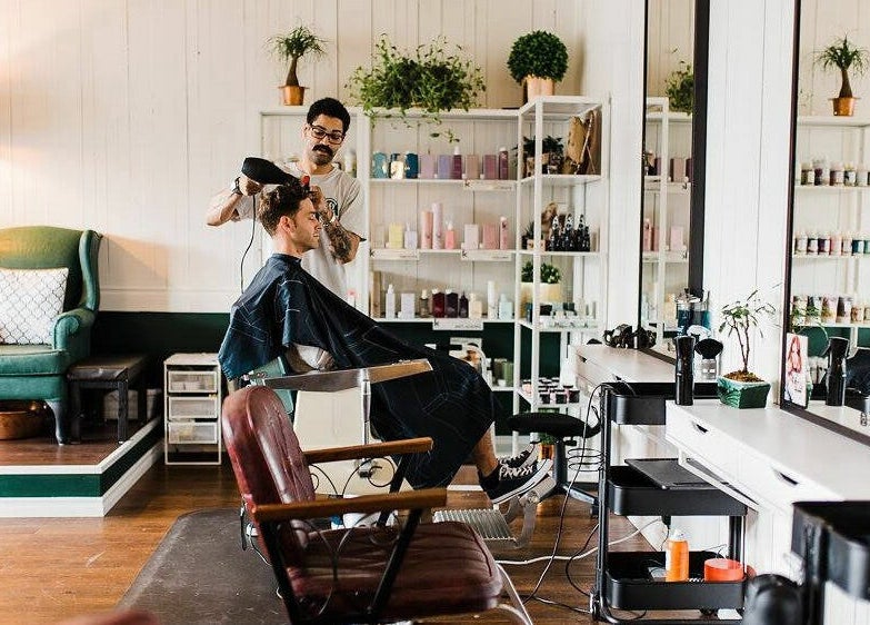 Stylist at Darling and Dapper Salon and Spa in Abbotsford, British Columbia, CA working with a client in a modern setup.