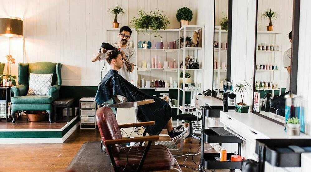 Stylist at Darling and Dapper Salon and Spa in Abbotsford, British Columbia, CA working with a client in a modern setup.