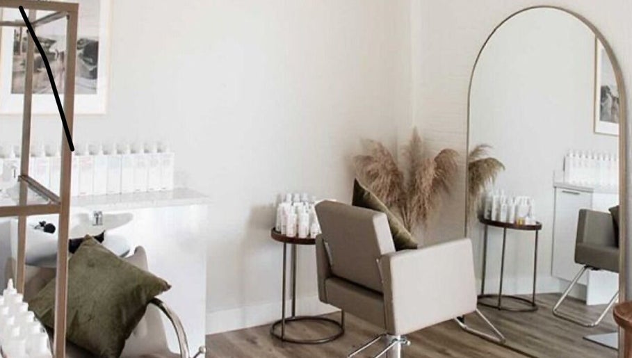Modern salon space at Her Wellness Space, Biggera Waters, Queensland, AU. Stylish decor and hair products visible.