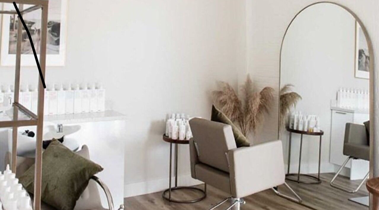 Modern salon space at Her Wellness Space, Biggera Waters, Queensland, AU. Stylish decor and hair products visible.