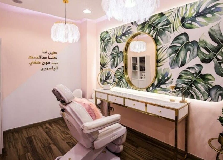 Relaxing salon interior at Touq AlYasmeen Ladies Salon, Sharjah, Sharjah, AE with floral wall and comfortable chair.