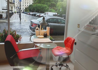 Cozy nail station at Wioletta Beauty - Fulham, capturing London elegance through a window view. London, England, GB.