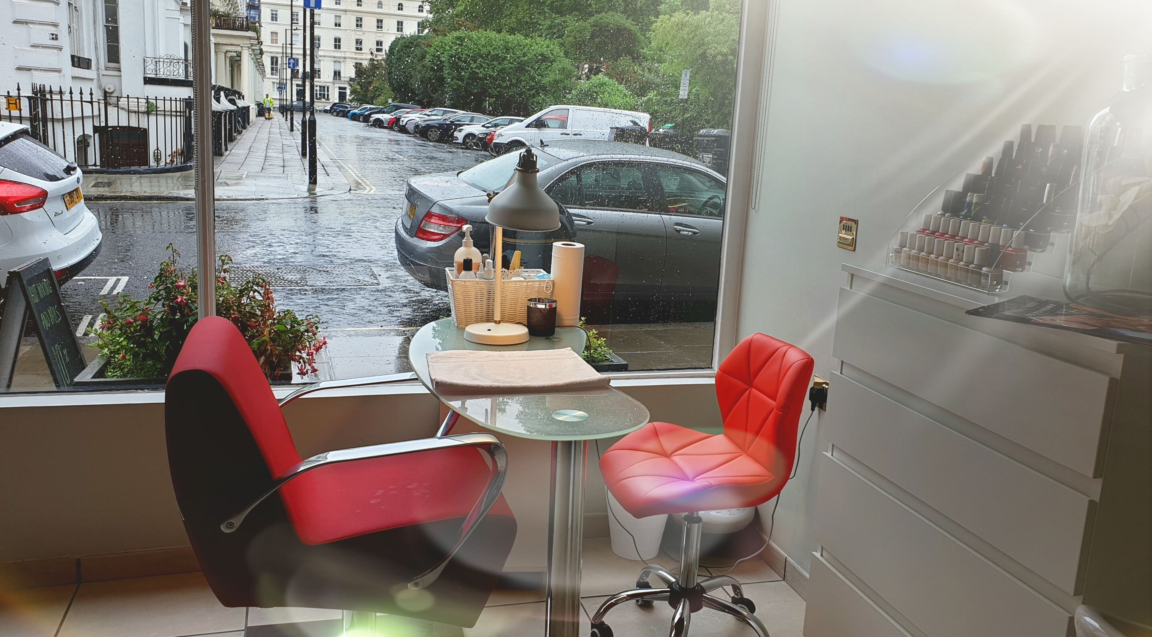 Cozy nail station at Wioletta Beauty - Fulham, capturing London elegance through a window view. London, England, GB.
